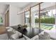 Elegant dining room with modern lighting, a large picture window and views of the outdoor pool at 1660 Palmer Ave, Winter Park, FL 32789