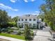 Beautiful two-story home with a landscaped front yard, manicured hedges and a paver driveway at 1660 Palmer Ave, Winter Park, FL 32789