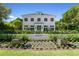 An elegant two-story home is beautifully landscaped and includes planters and manicured gardens at 1660 Palmer Ave, Winter Park, FL 32789