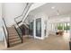 Spacious foyer featuring modern stairs with glass railings and a glass-enclosed wine storage area at 1660 Palmer Ave, Winter Park, FL 32789