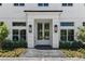 A charming front entry boasts a covered porch with black lanterns and beautiful double doors at 1660 Palmer Ave, Winter Park, FL 32789