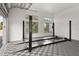 A large garage features a car lift, diamond patterned tiling, and natural light from windows at 1660 Palmer Ave, Winter Park, FL 32789
