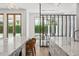 Spacious kitchen with marble countertops, seating at the island, and easy access to the outdoor pool area at 1660 Palmer Ave, Winter Park, FL 32789