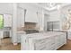 Modern white kitchen with stainless steel appliances, marble countertops, and a stylish backsplash at 1660 Palmer Ave, Winter Park, FL 32789
