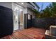 An outdoor patio with wood flooring, a water feature, and a view into a modern bathroom at 1660 Palmer Ave, Winter Park, FL 32789