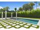 Backyard pool features a hot tub, pergola covered lounge area, and lush landscaping at 1660 Palmer Ave, Winter Park, FL 32789