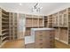 Spacious walk-in closet featuring custom shelving, cabinets, and an island with a countertop at 1660 Palmer Ave, Winter Park, FL 32789