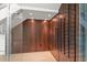 A custom-built, glass-enclosed wine storage area with wood paneling and metal wine racks at 1660 Palmer Ave, Winter Park, FL 32789