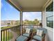 Serene balcony offers comfortable seating and scenic views of the community pool at 1763 White Feather Loop, Oakland, FL 34787
