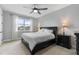 This primary bedroom features a ceiling fan and a view of the outdoors at 1763 White Feather Loop, Oakland, FL 34787