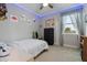 This bedroom features a ceiling fan, a window, and themed dinosaur decor at 1763 White Feather Loop, Oakland, FL 34787