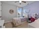 Charming bedroom with soft lavender accents, whimsical decor, and a cozy trundle bed at 1763 White Feather Loop, Oakland, FL 34787