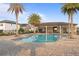 Community pool and recreation area featuring a covered pavilion with seating and palm trees at 1763 White Feather Loop, Oakland, FL 34787
