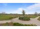 Well-maintained park area with benches and sidewalks surrounded by mature trees and lush landscaping at 1763 White Feather Loop, Oakland, FL 34787