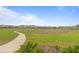 Picturesque walking path winds through a vibrant community with lush greenery and inviting scenery at 1763 White Feather Loop, Oakland, FL 34787