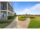 Scenic pathway leading to the homes, bordered by lush greenery and manicured lawns at 1763 White Feather Loop, Oakland, FL 34787
