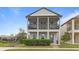 Charming two-story home featuring a welcoming double porch and verdant landscaping at 1763 White Feather Loop, Oakland, FL 34787