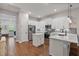 Modern kitchen with stainless steel appliances, white cabinetry and a center island at 1763 White Feather Loop, Oakland, FL 34787