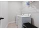 Functional laundry room with modern washer and dryer, featuring overhead shelving for storage at 1763 White Feather Loop, Oakland, FL 34787