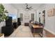 Inviting living room features a comfortable sectional sofa, hardwood floors, and bright natural light at 1763 White Feather Loop, Oakland, FL 34787