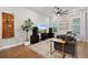 Comfortable living room includes a sectional sofa, hardwood floors, a ceiling fan, and natural light at 1763 White Feather Loop, Oakland, FL 34787