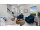 Cozy living room with wood floors, comfortable seating and natural light at 1763 White Feather Loop, Oakland, FL 34787