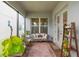 Inviting covered patio features cozy seating area and stylish decor creating a relaxing outdoor space at 1763 White Feather Loop, Oakland, FL 34787