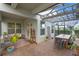 Spacious screened patio boasts ample seating and stylish design perfect for entertaining or relaxation at 1763 White Feather Loop, Oakland, FL 34787