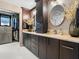 Bathroom featuring dual sinks, dark wood cabinetry, marble countertops and a walk-in closet at 1765 Torrington Cir, Longwood, FL 32750