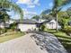 Beautiful home with a well maintained lawn, stunning brick driveway, and lush tropical landscaping at 1765 Torrington Cir, Longwood, FL 32750