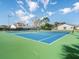 Community tennis court featuring a blue and green court surface, nets, and lighting for evening play at 1765 Torrington Cir, Longwood, FL 32750