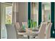 Elegant dining area with a view through the sliding glass door and modern decor, including a sleek white table at 1857 Walnut Creek Dr, Kissimmee, FL 34744