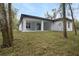 A spacious backyard featuring a covered patio and well-maintained lawn, perfect for outdoor entertaining at 2160 7Th Ave, Deland, FL 32724