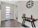 Bright foyer with wood-look floors, stylish console table, and modern door with glass panel at 2160 7Th Ave, Deland, FL 32724