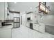 Spacious kitchen featuring white cabinetry, stainless steel appliances, and a modern, geometric light fixture at 2160 7Th Ave, Deland, FL 32724