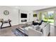 Open living room with modern furnishings, stylish rug, and sliding glass doors to the backyard at 2160 7Th Ave, Deland, FL 32724