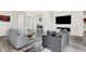 Spacious living room featuring modern furnishings, a large wall-mounted TV, and stylish decor at 2160 7Th Ave, Deland, FL 32724
