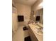 Cozy bathroom featuring a vanity with a sink and a shower with a patterned wall covering at 2284 Firestone Pl, Winter Haven, FL 33884