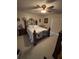 Cozy bedroom featuring a decorative bed frame, ceiling fan, and sliding glass door for natural light at 2284 Firestone Pl, Winter Haven, FL 33884
