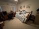 Bedroom with a comfortable bed, desk, and window creating a cozy and functional space at 2284 Firestone Pl, Winter Haven, FL 33884