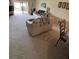 Spacious living room with neutral carpet, comfortable sofa, and sliding glass doors for bright natural light at 2284 Firestone Pl, Winter Haven, FL 33884