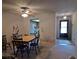 Cozy living room with dining area featuring unique wall decor, and access to kitchen at 2284 Firestone Pl, Winter Haven, FL 33884