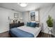 Light-filled bedroom with geometric accent wall, two windows, wood floors, and modern furnishings at 2715 Kilgore Street St, Orlando, FL 32803