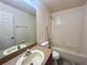 A bathroom with a vanity, a mirror, a toilet, and a bathtub with a shower at 2946 Ashland S Ln, Kissimmee, FL 34741