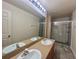 Bathroom featuring double vanity and glass enclosed shower at 2946 Ashland S Ln, Kissimmee, FL 34741