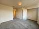 A cozy bedroom with neutral carpet and walls, a closet, and a simple overhead light fixture at 2946 Ashland S Ln, Kissimmee, FL 34741