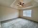 Bright bedroom with tray ceiling, carpet flooring, and a ceiling fan at 2946 Ashland S Ln, Kissimmee, FL 34741