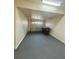 Spacious garage with painted walls, concrete floor, and an overhead garage door at 2946 Ashland S Ln, Kissimmee, FL 34741