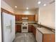 Functional kitchen with white appliances and wood cabinets at 2946 Ashland S Ln, Kissimmee, FL 34741