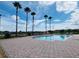 Community pool featuring palm trees and a clear blue sky at 2946 Ashland S Ln, Kissimmee, FL 34741